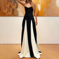 Vestido de férias bicolor preto e branco com saia fluida e alças finas, ideal para verão e eventos formais.